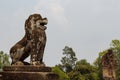 Mossy stone lion statue, Angkor Wat complex, Cambodia. Ancient temple in Siem Reap.