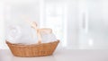 Mossy white towel in a basket on a white table Royalty Free Stock Photo