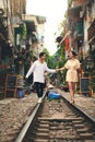 The most beautiful chapter of their love story. a young couple walking on the train tracks through the streets of Royalty Free Stock Photo