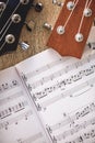 Most Beautiful Guitar Music. Close-up view of guitar necks and music notes against of wooden background