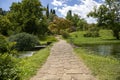 The bridge in cobblestones and the greenery of the Garden of Ninfa in Italy in the province of Latina.