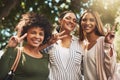 We are the most chilled cats around. Portrait of a cheerful young group of friends standing together while showing the Royalty Free Stock Photo