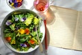 Edible flowers salad and flower tea as a healthy and happy Sunday snack or brunch