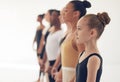 The most essential thing in dance discipline is devotion. a group of ballerinas getting ready to perform in a dance