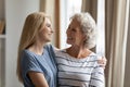 Happy mature mother cuddling warm smiling grownup daughter Royalty Free Stock Photo