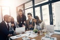 It really is the most feasible option. a group of young businesspeople using a laptop together during a meeting in a