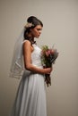 The most gorgeous bride. Studio shot of a young beautiful bride posing against a grey background.