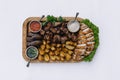 Most meat dish - beef kebabs, sausages, grilled mushrooms, potatoes, tomatoes and sauce. The best choice for a beer. Close-up on a Royalty Free Stock Photo