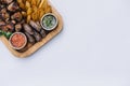 Most meat dish - beef kebabs, sausages, grilled mushrooms, potatoes, tomatoes and sauce. The best choice for a beer. Close-up on a Royalty Free Stock Photo