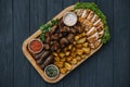 Most meat dish - beef kebabs, sausages, grilled mushrooms, potatoes, tomatoes and sauce. The best choice for a beer. Close-up on a Royalty Free Stock Photo