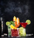 Most popular cocktail drinks set: aperol spritz, negroni, mojito, gin tonic and cosmopolitan on black bar counter background with Royalty Free Stock Photo