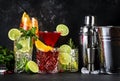 Most popular cocktail drinks set: aperol spritz, negroni, mojito, gin tonic and cosmopolitan on black bar counter background with Royalty Free Stock Photo