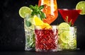 Most popular cocktail drinks set: aperol spritz, negroni, mojito, gin tonic and cosmopolitan on black bar counter background Royalty Free Stock Photo