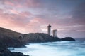 Most popular lighthouse in Europe during stormy weather. Petit Minou Lighthouse at sunset with red light, Brest , France Royalty Free Stock Photo