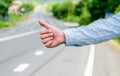 Most popular way of hitchhiking is to thumb up. Hand thumb up gesture try stop car road background. Thumb or hand Royalty Free Stock Photo