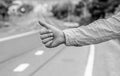 Most popular way of hitchhiking is to thumb up. Hand thumb up gesture try stop car road background. Thumb or hand Royalty Free Stock Photo