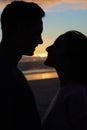 The most romantic date is at sunset. Silhouette shot of a young couple on the beach. Royalty Free Stock Photo