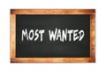 MOST WANTED text written on wooden frame school blackboard