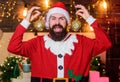 Most wonderful time of year. Bearded man Santa Claus decorating christmas tree with golden decorations. Winter Royalty Free Stock Photo