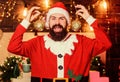 Most wonderful time of year. Bearded man Santa Claus decorating christmas tree with golden decorations. Winter Royalty Free Stock Photo