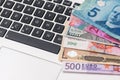 Most world paper money with laptop Royalty Free Stock Photo