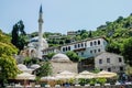 Mostar, Bosnia - June 1, 2019: View of the main mosque of the city, in the sun next to a bar where you can have a drink