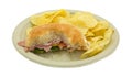 Mostly eaten salami sub sandwich on plate with chips Royalty Free Stock Photo