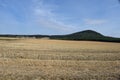 mostly harvestedwheat fields with a volcano hill behind Royalty Free Stock Photo