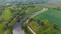 The MotÃâawa River flows smoothly between green fields. Poland. Royalty Free Stock Photo