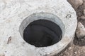 Motage of a concrete sewer well with a gate valve at a construction site. Close-up. Late communications