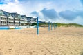 Motel and beach with volleyball courts on the shores of the Atlantic Ocean under a cloudy sky