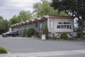 A motel almost empty with only one car parked at the front
