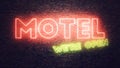 Motel neon sign mounted on brick wall