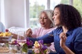 Mother And Adult Daughter Enjoying Multi-Generation Family Meal At Home Royalty Free Stock Photo