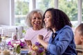 Mother And Adult Daughter Enjoying Multi-Generation Family Meal At Home Royalty Free Stock Photo