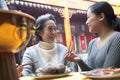 Mother and adult daughter enjoying traditional Chinese meal Royalty Free Stock Photo