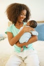 Mother African American holding one-month-old newborn baby gently. Royalty Free Stock Photo