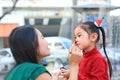 Mother applying makeup on her daughter face Royalty Free Stock Photo