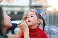 Mother applying makeup on her daughter face Royalty Free Stock Photo