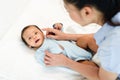 mother applying moisturizing cream on face of newborn baby Royalty Free Stock Photo