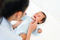mother applying moisturizing cream on face of newborn baby Royalty Free Stock Photo