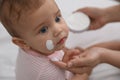 Mother applying moisturizing cream on her baby, closeup Royalty Free Stock Photo