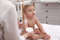 Mother applying moisturizing cream on her little baby at home, closeup Royalty Free Stock Photo