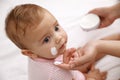 Mother applying moisturizing cream on her little baby, closeup Royalty Free Stock Photo
