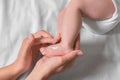 Mother applying moisturizing cream onto baby`s foot on bed, top view Royalty Free Stock Photo