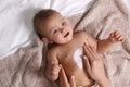 Mother applying moisturizing cream onto her little baby`s skin on towel, closeup Royalty Free Stock Photo