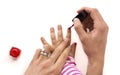 Mother applying nail polish to her little girl isolated Royalty Free Stock Photo