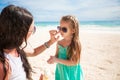 Mother applying sunblock cream on her child nose Royalty Free Stock Photo