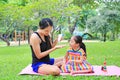 Mother appying body lotion for daughter`s in the summer park Royalty Free Stock Photo