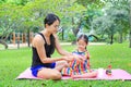 Mother appying body lotion for daughter`s in the summer park Royalty Free Stock Photo